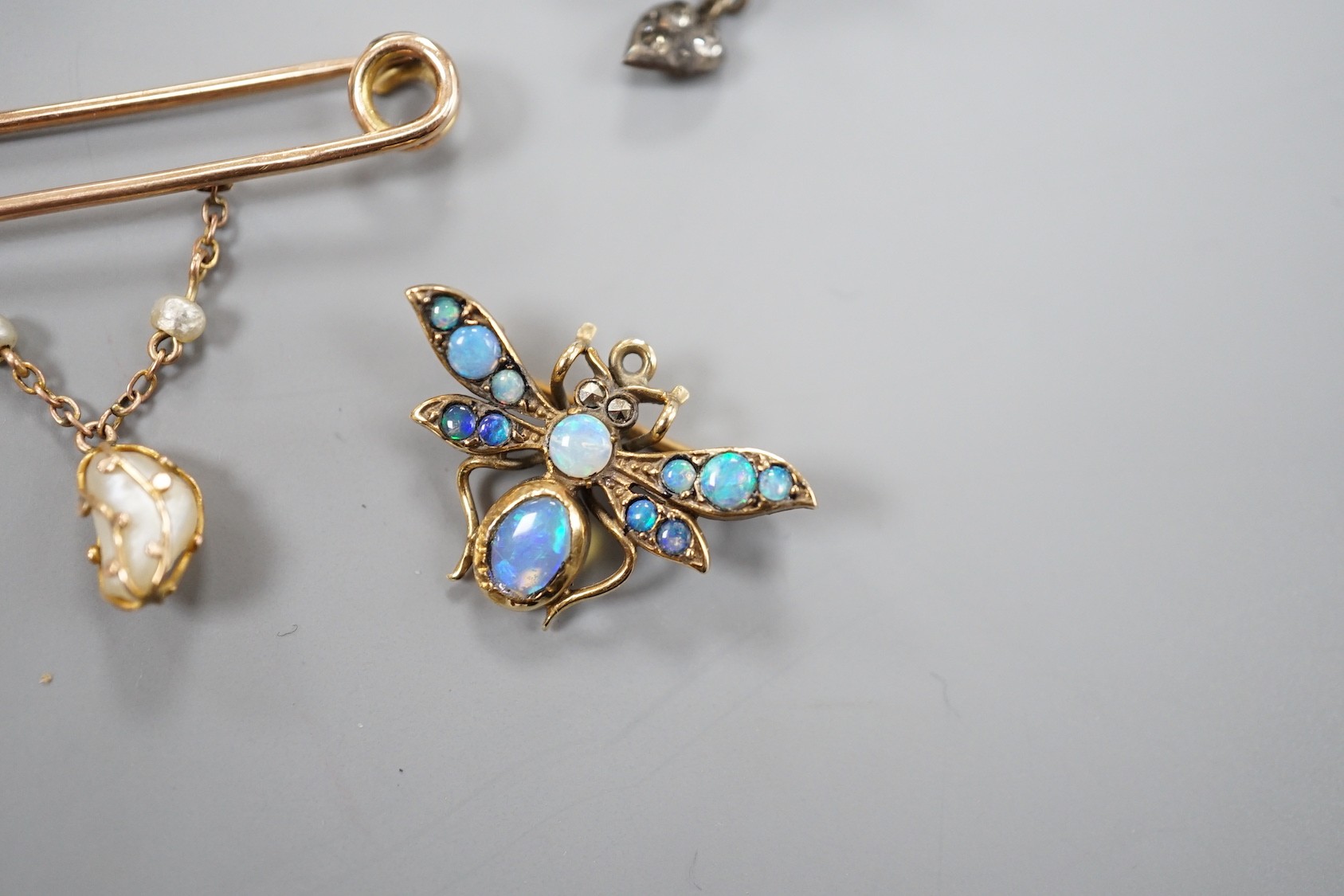 A modern 9ct gold and opal set bug brooch, 24mm, a paste set white metal swallow pendant and similar brooch and two yellow metal bar brooches, one with gem set spider, the other with baroque pearl drop.